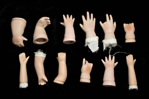 istock Broken Doll Body Parts on Black Background 534307864