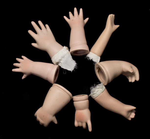 istock Broken Doll Body Parts on Black Background 534308346