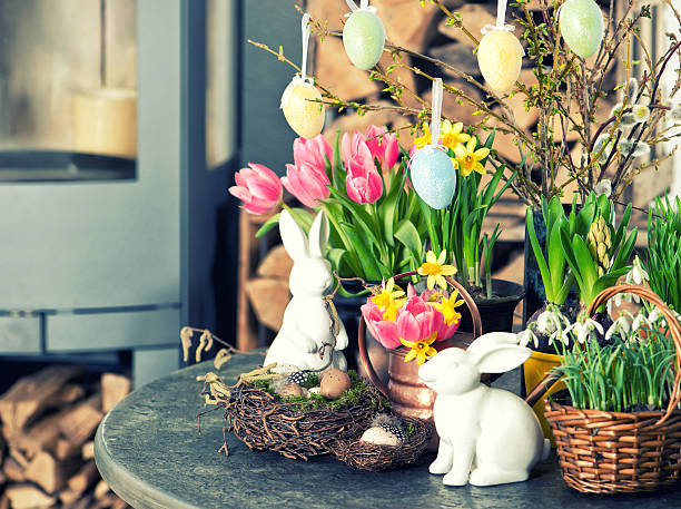 Easter decoration with flowers and eggs. Tulips and narcissus Easter decoration with flowers and eggs. Tulips, snowdrops and narcissus blooms on white background. Selective focus. Vintage style toned picture forsythia garden stock pictures, royalty-free photos & images