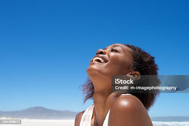 Beautiful Young African Woman Laughing Outdoors Stock Photo - Download Image Now - Women, One Woman Only, African Ethnicity