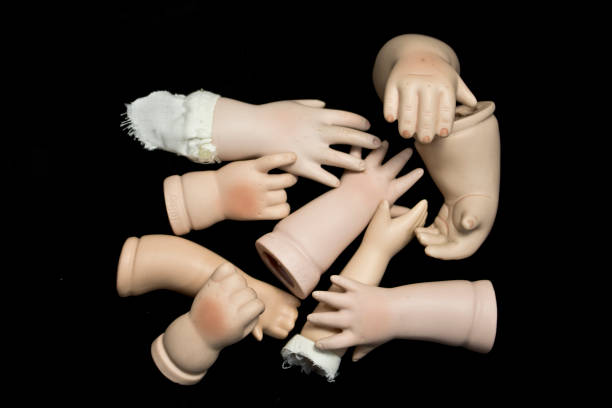 istock Broken Doll Body Parts on Black Background 534308734