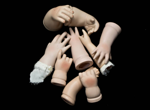 istock Broken Doll Body Parts on Black Background 534308974