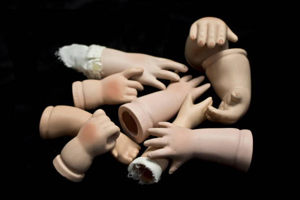 istock Broken Doll Body Parts on Black Background 534309228