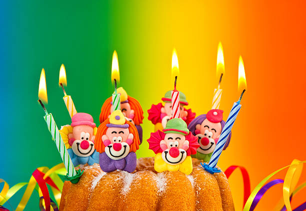 Smiling senior man holding a birthday cake.