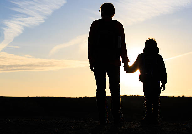 istock father and son travel at sunset 534310156