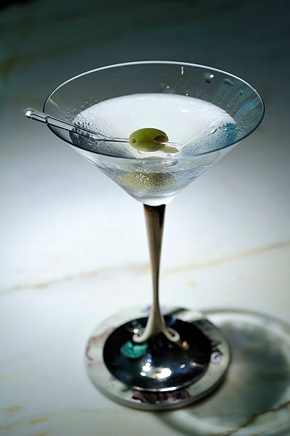 istock martini with green olives on a table in bar 534310231