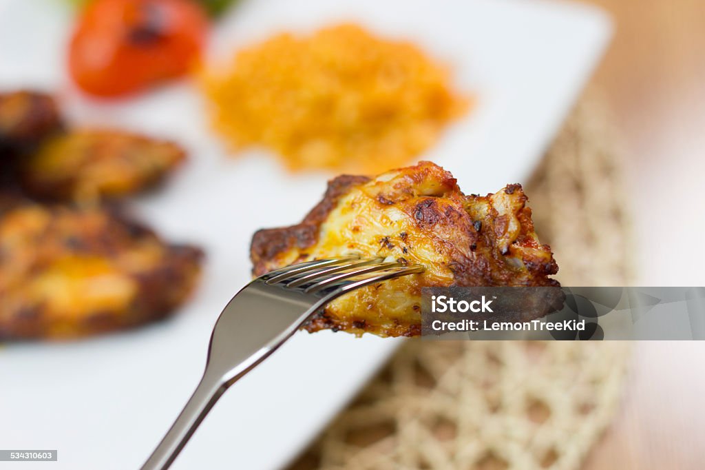 Chicken wing barbecue close up Single chicken wing on fork 2015 Stock Photo