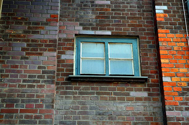 istock small window of an industrial building with brick wall 534311226