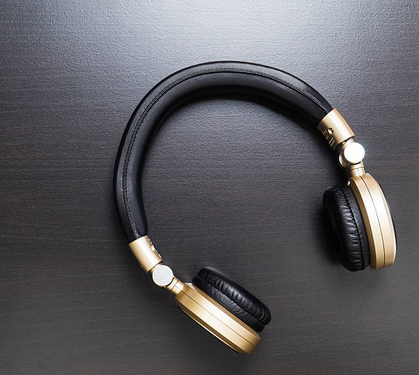 istock golden wireless headphone on a black shiny wood 534311284
