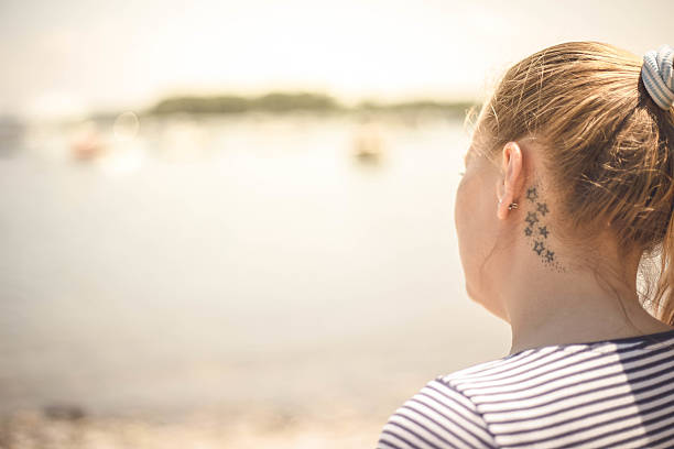 istock Young woman relaxing by the lake. 534311572