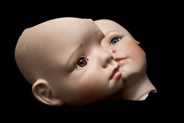 istock Broken Doll Body Parts on Black Background 534312096
