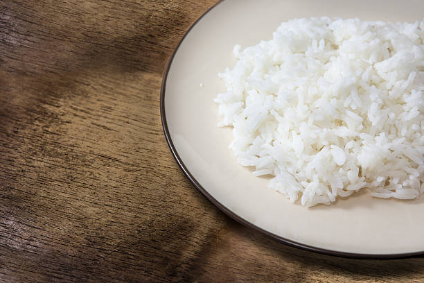 istock dish of white boiled rice on wood background 534312205