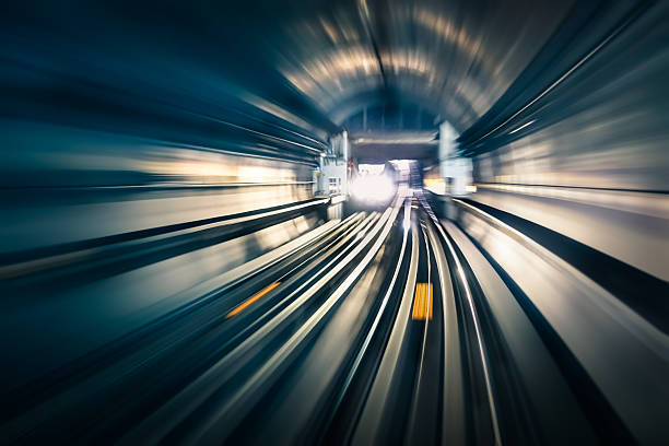 Subway tunnel with blurred light tracks with arriving train Subway tunnel with blurred light tracks with arriving train in the opposite direction - Concept of modern metro underground transport and connection speed tokyo bullet train stock pictures, royalty-free photos & images