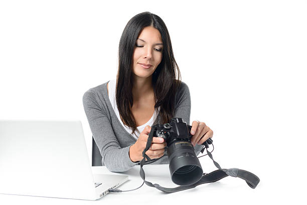 istock Female photographer checking an image on a camera 534313145