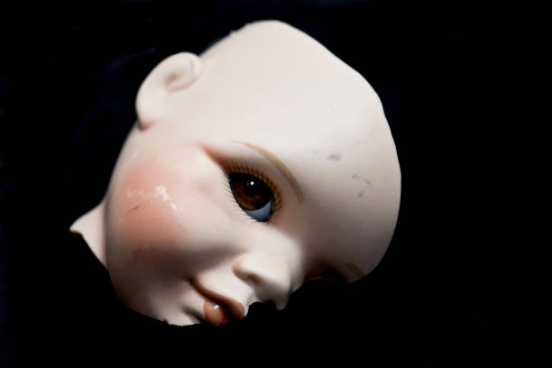 Doll Body Parts on Black Background, legs, arms, head, broken