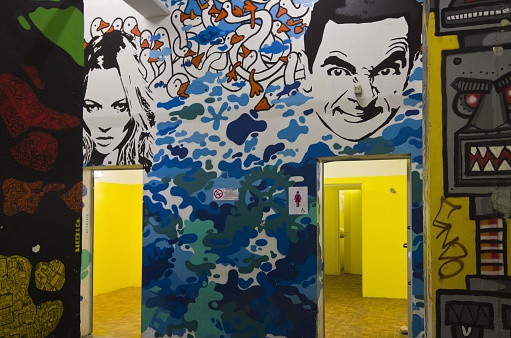 Milan, Italy - April 8, 2014: Public toilette of the Spazio Ansaldo in Milan during the Fuorisalone in Milan on April 8 2014, with Kate Moss paint for the ladies and Mr.Bean for the men
