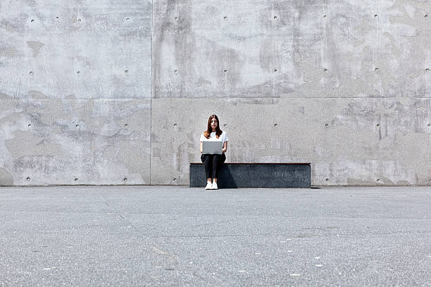 istock girl, laptop, concrete 534313986