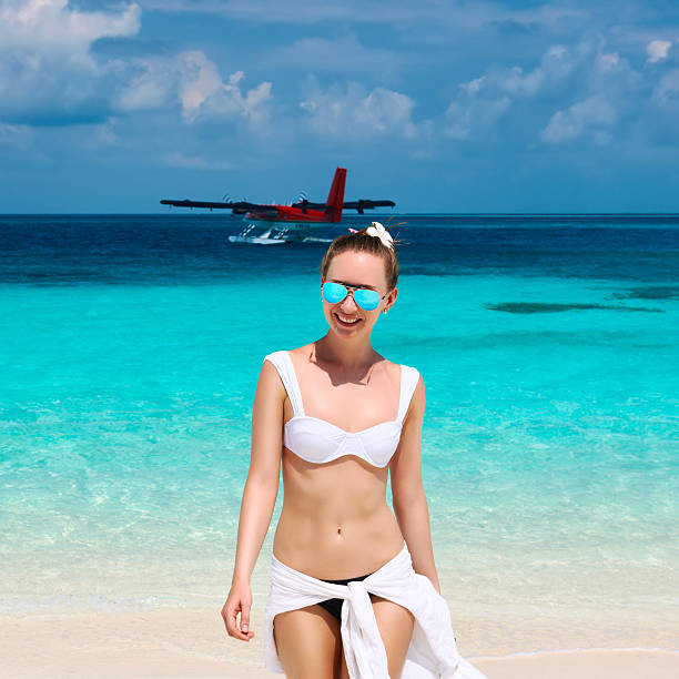 istock Woman at beach. Seaplane at background. 534314035