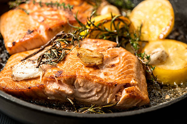 istock Grilled salmon fish with herbs, garlic and lemon 534314241