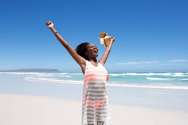 istock Laughing young woman standing on beach 534314522