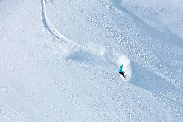 Photo of Skier skiing off-piste on a beatiful mountain slope