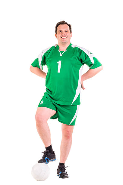 Mature man dressed in green sportswear posing