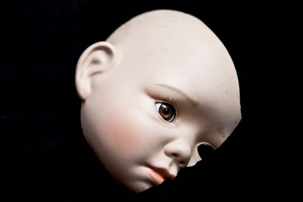 istock Broken Doll Body Parts on Black Background 534314964
