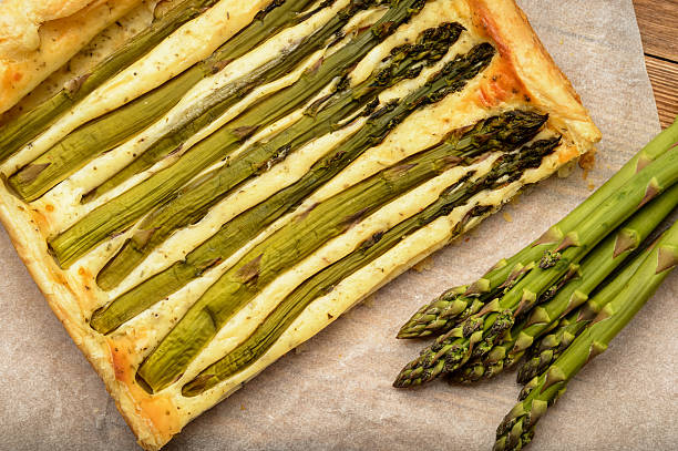 istock Tart with green asparagus on wooden table. 534317810