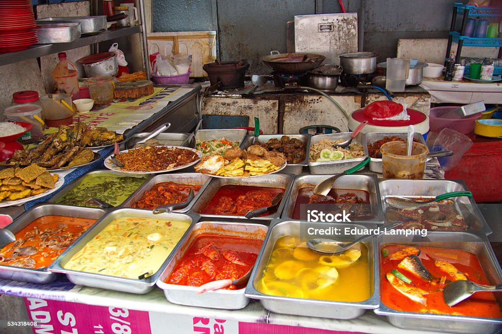 'Hawker Foodstall' in the streets of Kuala Lumpur, Malaysia. Hawker Foodstall, in the streets of Kuala Lumpur, Malaysia with a broad selection of fresh made and colorful, very tasty Malaysian Food, to take away or eat instantly on the street. Asia Stock Photo