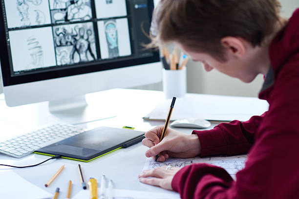 Artist at work Young designer sketching at the table young graphic designer stock pictures, royalty-free photos & images