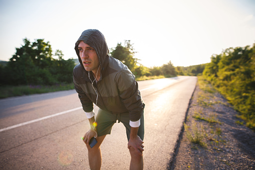 Photo of exhausted runner on the road