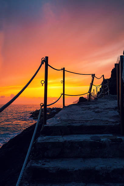 istock Stairways in rock over sea at sunset 534318534