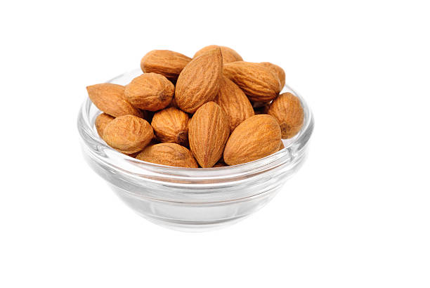 istock Dried almonds on glass bowl isolated on a white background 534320662