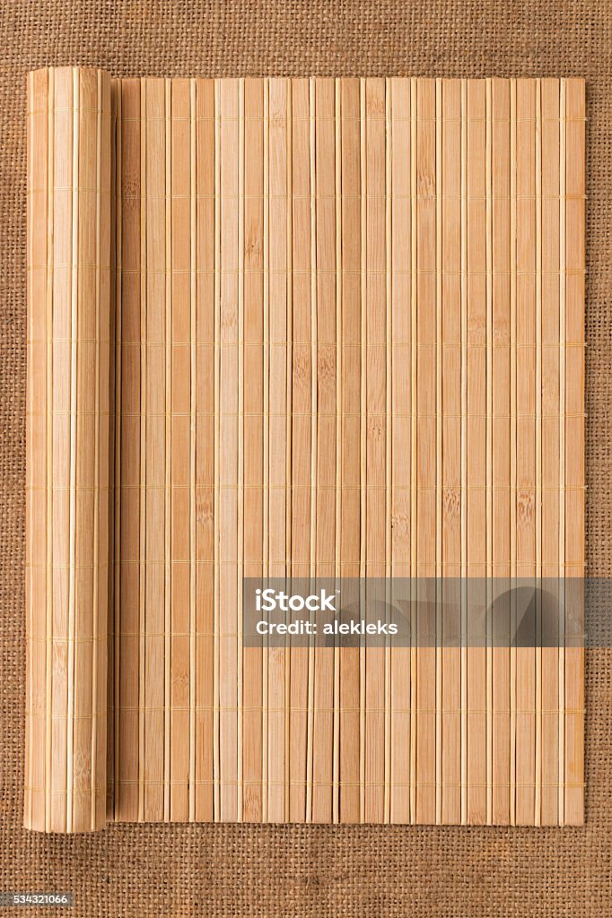 Bamboo mat twisted in the form of a manuscript Bamboo mat twisted in the form of a manuscript on sackcloth, with space for your text Paper Scroll Stock Photo