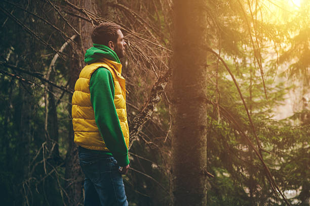 istock Young man stands in the woods and enjoying the view. 534321126