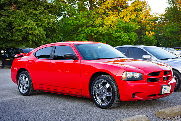 First Generation Red Dodge Charger LX Hamilton, Canada - August 23, 2013: A red colored, first generation Dodge Charger LX parked in a parking lot in Hamilton, Ontario. dodge charger stock pictures, royalty-free photos & images