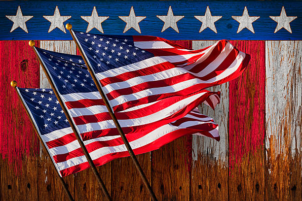 istock Three US Flags Waving Patrotic Stars and Stripes Rustic Background 534321658