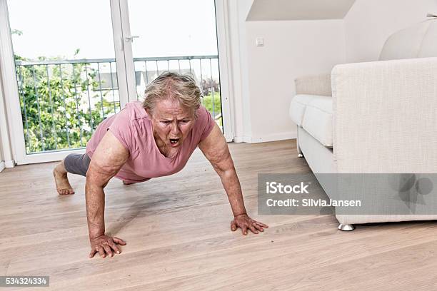 Active Senior Woman With Overweight Exercising Stock Photo - Download Image Now - One Woman Only, Women, Colored Background