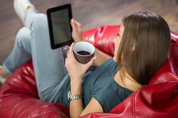 Woman reading an ebook at her home