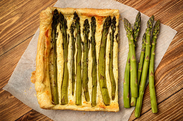 istock Tart with green asparagus on wooden table. 534328516