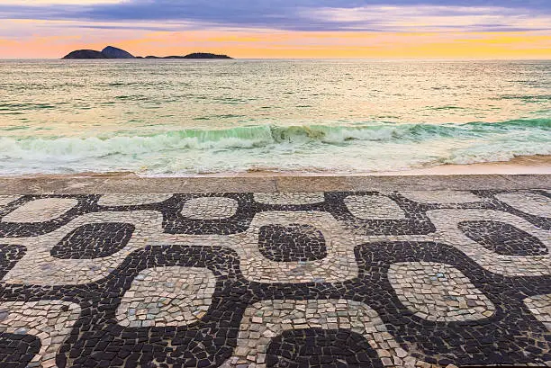 Sunset view of Ipanema beach with mosaic of sidewalk in Rio de Janeiro. Brazil