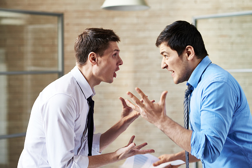 Two businessmen fighting at office