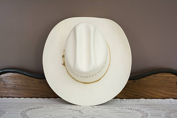istock White Cowboy Hat on an Antique Cabinet Front View 534333282