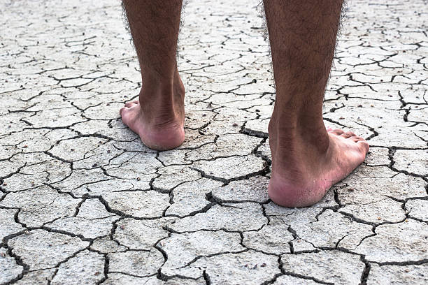 istock Drought area young man on dry soil. 534335134