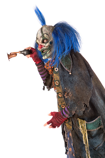 Creepy Clown holding a brass horn
