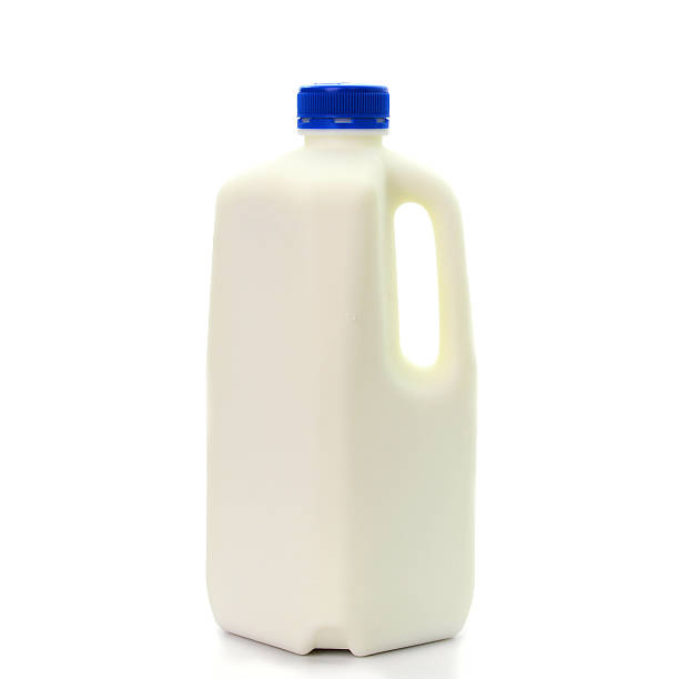 Milk Bottle with blud Cap Isolated on White Background Milk Bottle with blud Cap Isolated on White Background jug stock pictures, royalty-free photos & images