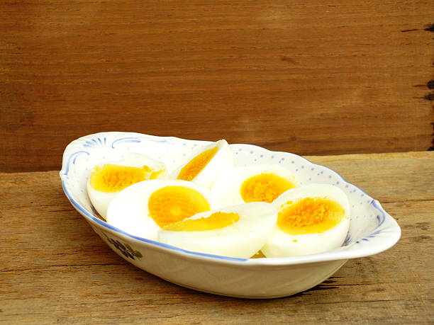 istock boiled eggs on plate and wooden background close up 534336880