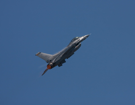 Lakewood, United States - July 17, 2010: Joint Base Lewis-McChord opens its gates to the public for a free airshow every few years.  This image shows an F-16 in flight over the show. 