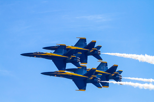 Silhouettes of seven fighter planes with smoke in airshow. Clear blue sky with copy space. Image taken with Hasselblad H3D Camera System and developed from RAW.