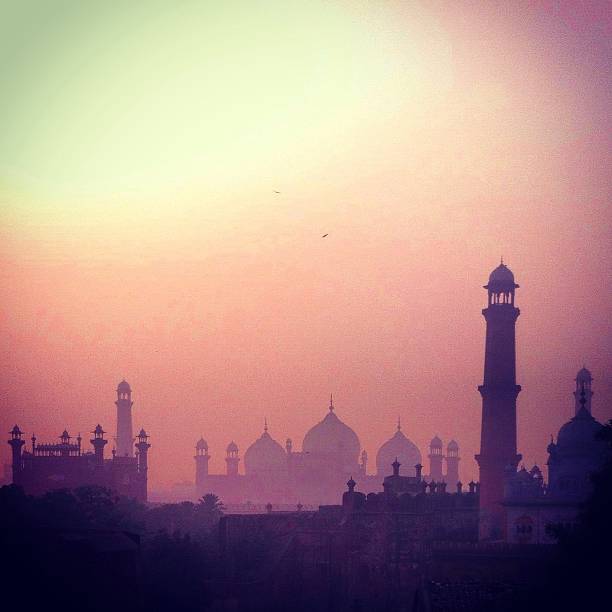 Silhouette of mosques Silhouette of mosque and minarets show as the sunsets on a hazy day in Lahore, Pakistan lahore pakistan photos stock pictures, royalty-free photos & images